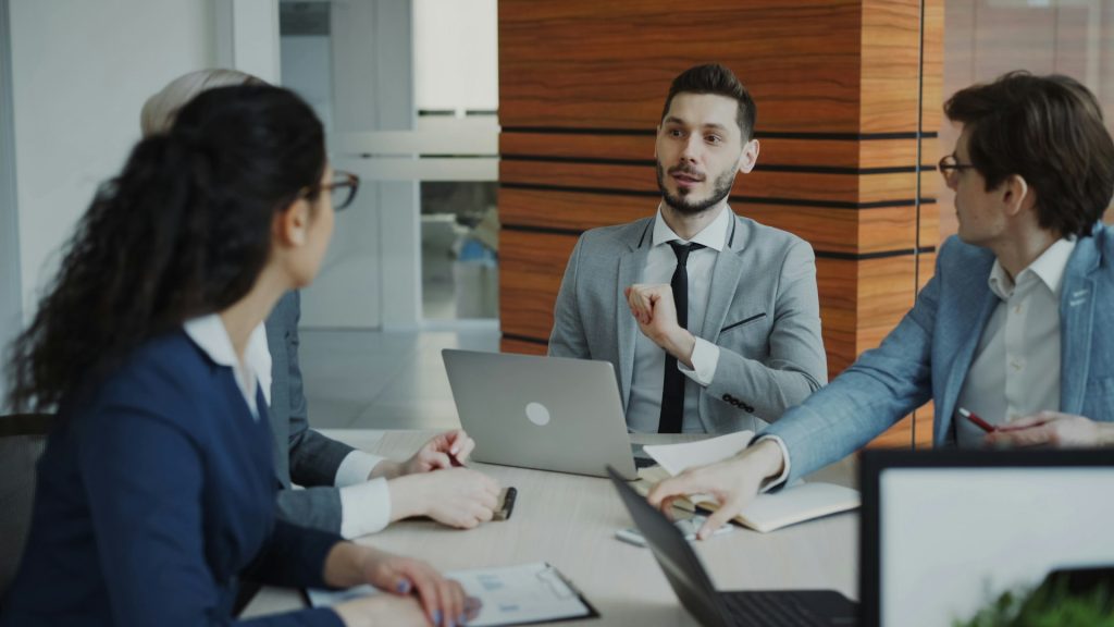 A small team meeting around a laptop